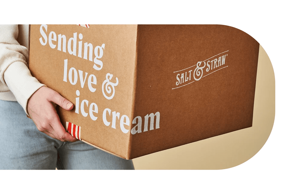 Person holding a Salt & Straw shipping box